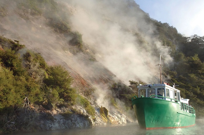 Watch the steam rising from the fuming cliffs - Waimangu . Volcanic Valley