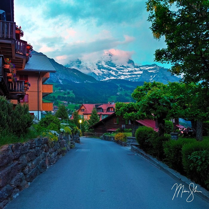 Colors begin to light up in the mountains above Wengen Village, Switzerland