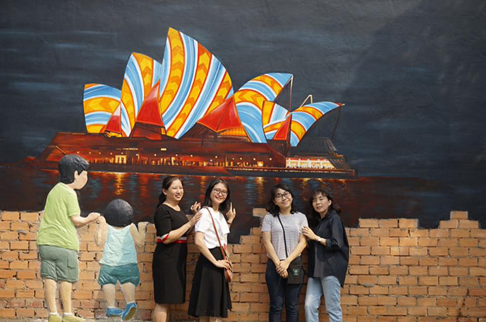 Check in the frescoed village of Cao Lanh - a painting of Sydney Opera House