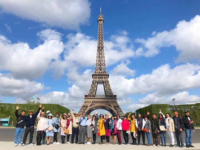 Khách chụp ảnh lưu niệm trước tháp Eiffel